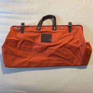 Line of Trade burnt orange duffel with leather handles and accessories